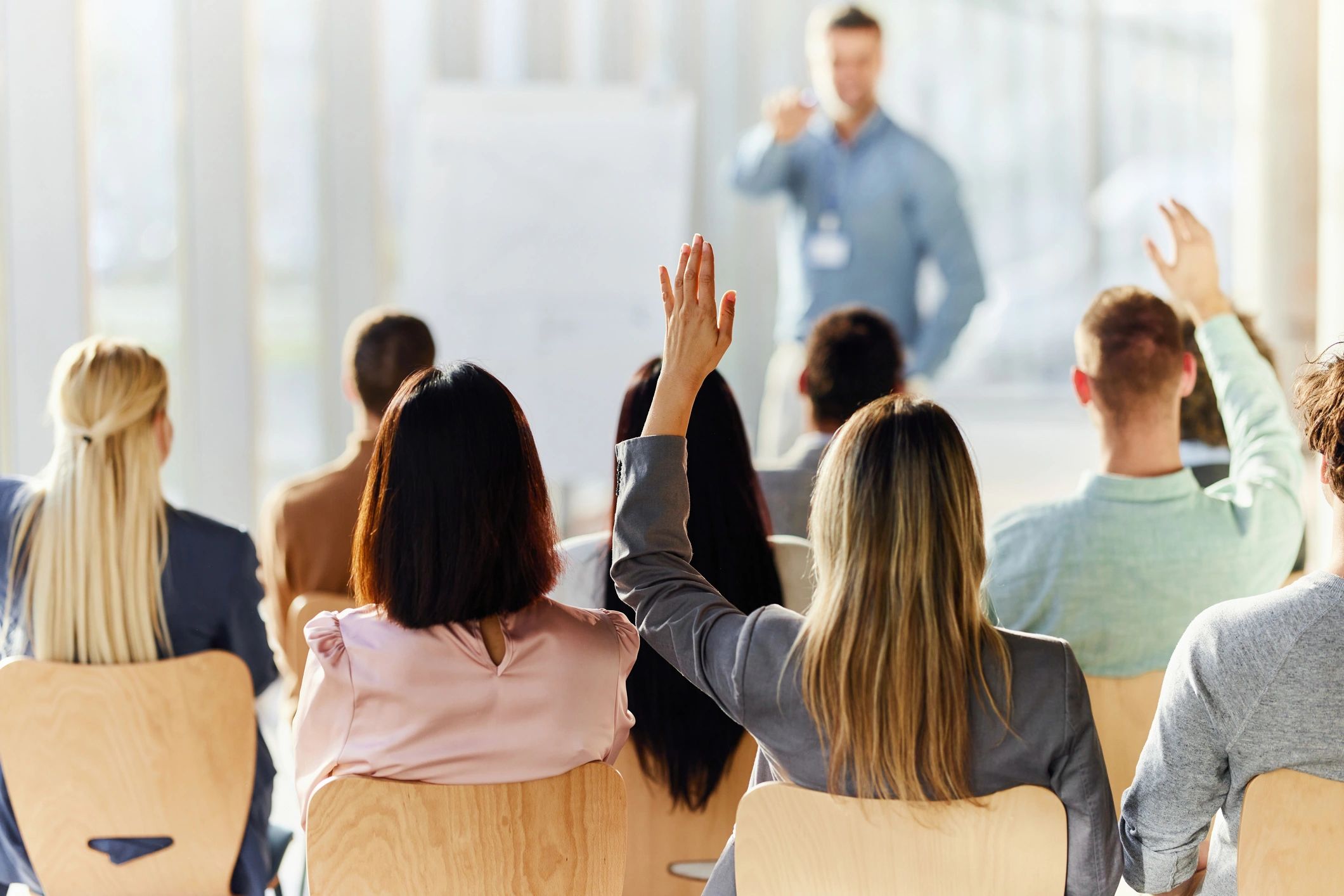 Businesswoman raising her hand during a meeting