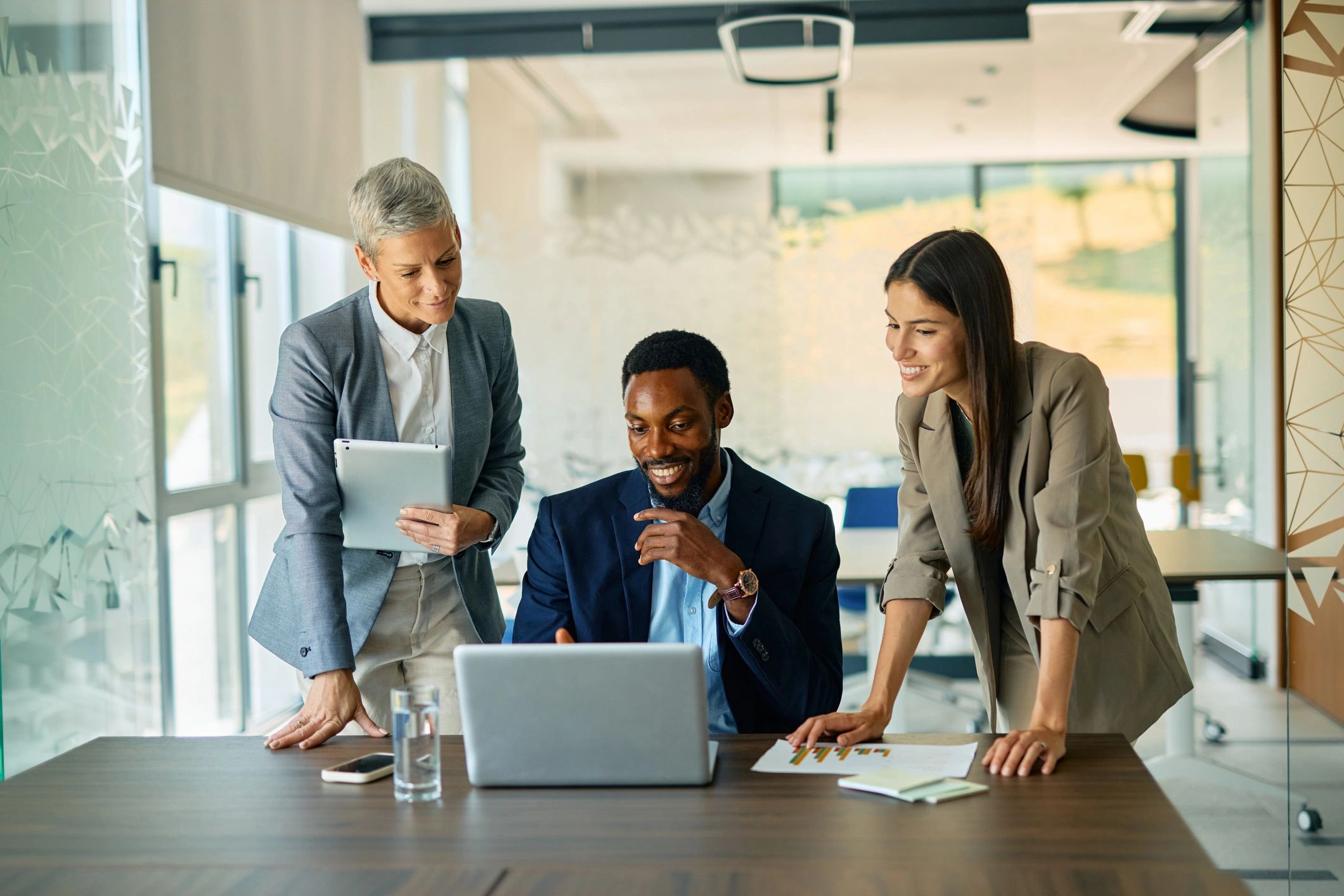 Business team collaborating on a laptop